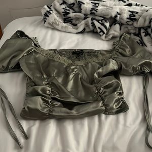 green blouse with lace trim